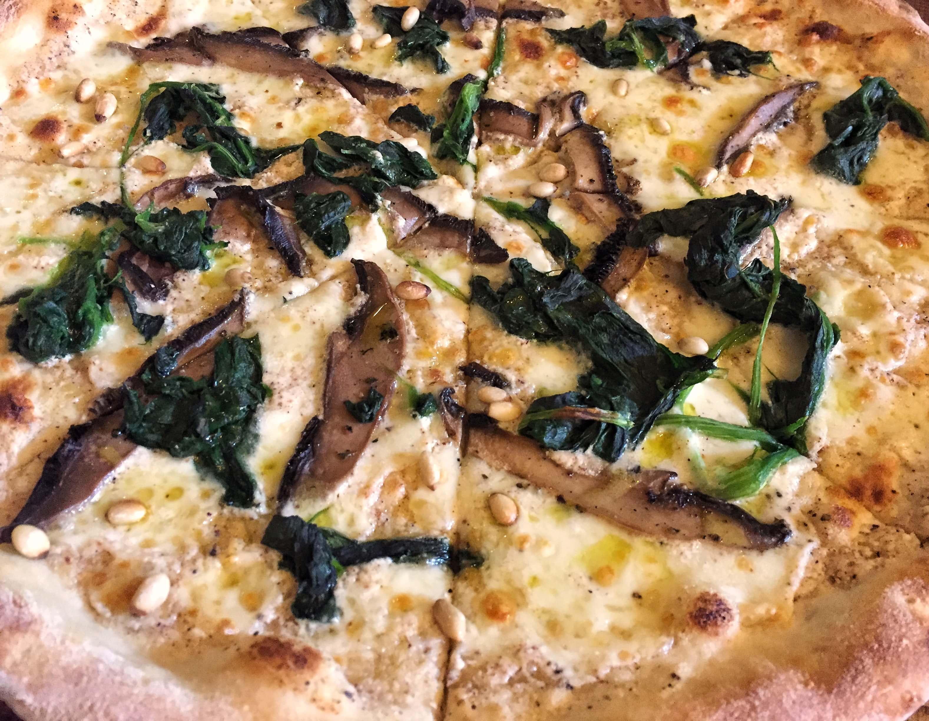 Pizza with Portobello mushrooms, spinach, pine nuts and truffle oil at The Coach and Horses, Clapham, London