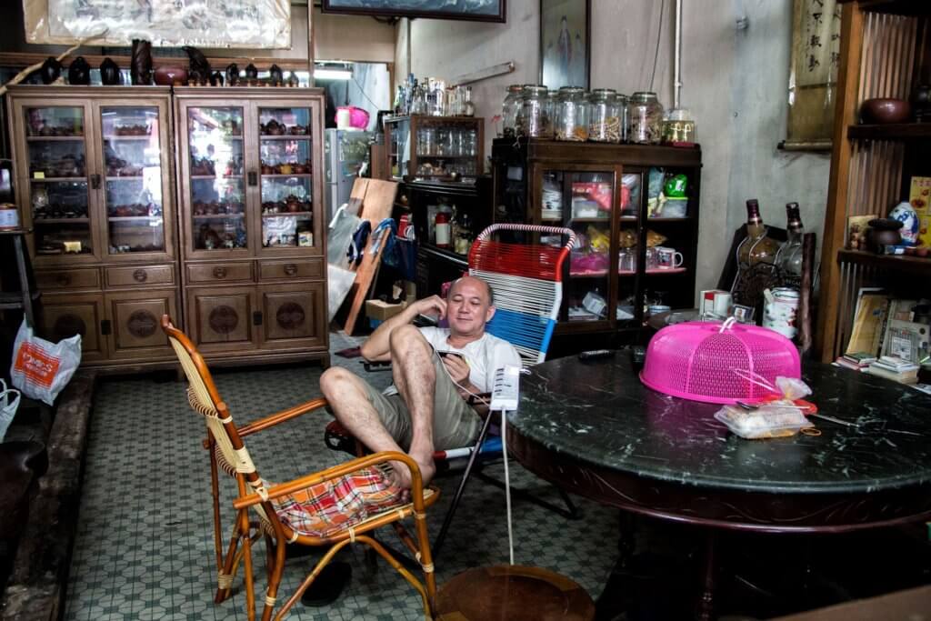 An antique shop and its owner in Melaka/Malacca, Malaysia