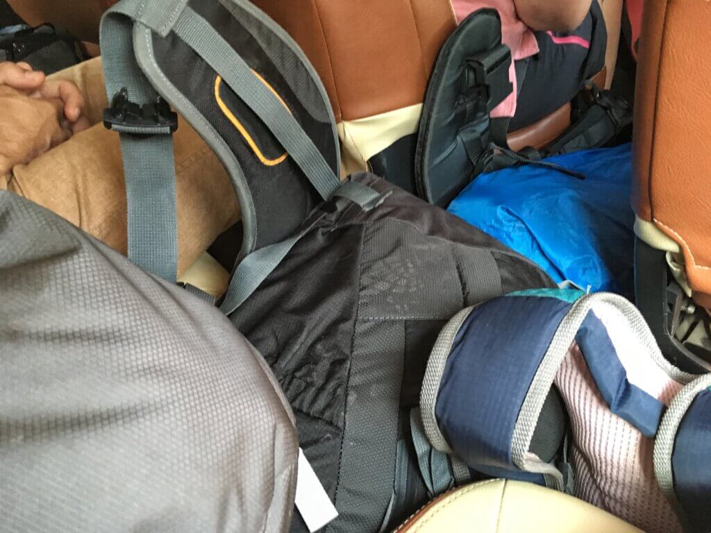 Piles of luggage in the aisle of a bus to Luang Namtha. Laos